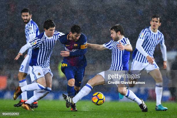Lionel Messi of FC Barcelona competes for the ball withIgor Zubeldia and Asier Illarramendi of Real Sociedad de Futbol during the La Liga match...