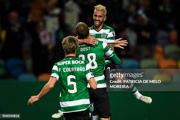 Sporting's Dutch forward Bas Dost celebrates a goal with Sporting's midfielder Ruben Ribeiro and Sporting's defender Fabio Coentrao during the...