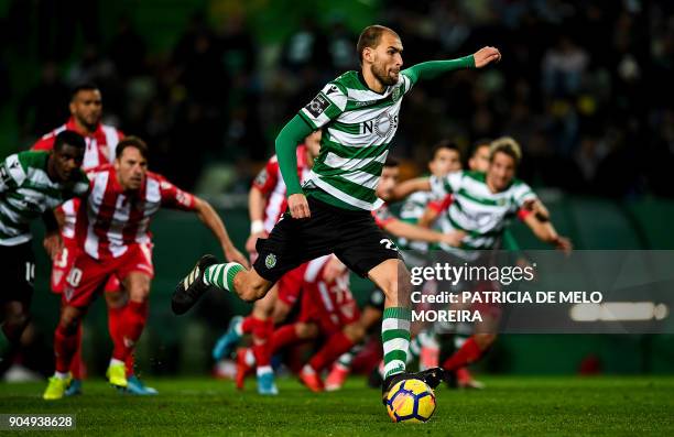 Sporting's Dutch forward Bas Dost shoots a penalty kick to score a goal during the Portuguese league football match between Sporting CP and CD Aves...
