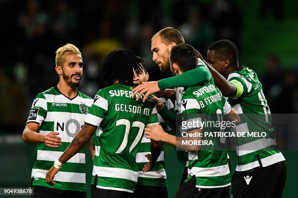 Sporting's Dutch forward Bas Dost celebrates a goal with teammates during the Portuguese league football match between Sporting CP and CD Aves at the...
