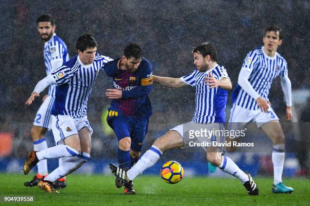 Lionel Messi of FC Barcelona competes for the ball withIgor Zubeldia and Asier Illarramendi of Real Sociedad de Futbol during the La Liga match...