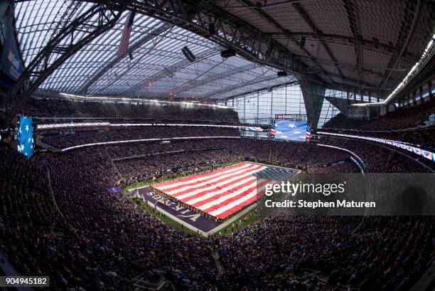 An American Flag is unfurled during the signing of the national anthem before the NFC Divisional Playoff game between the Minnesota Vikings and New...