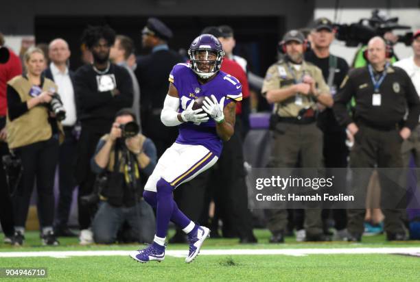 Jarius Wright of the Minnesota Vikings catches the ball in the first quarter of the NFC Divisional Playoff game against the New Orleans Saints on...