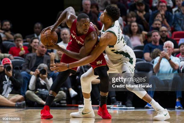 Miami Heat center Bam Adebayo looks for an open teammate as Milwaukee Bucks forward Giannis Antetokounmpo blocks in the fourth quarter on Sunday,...