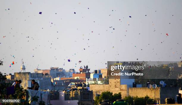 People flying kites on the occasion of Makar Sakranti at wall city of Jaipur, Rajasthan,India on 14 January 2018.