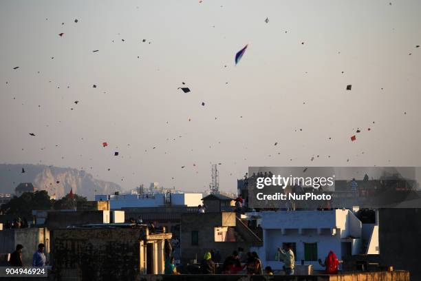 People flying kites on the occasion of Makar Sakranti at wall city of Jaipur, Rajasthan,India on 14 January 2018.