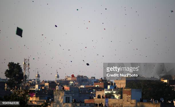 People flying kites on the occasion of Makar Sakranti at wall city of Jaipur, Rajasthan,India on 14 January 2018.