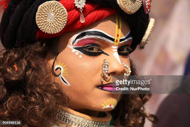 An Indian dressup artist of ' Lord Krishna' during the Kite Festival on the occasion of Makar Sakranti at Jal Mahal of Jaipur, Rajasthan,India on 14...