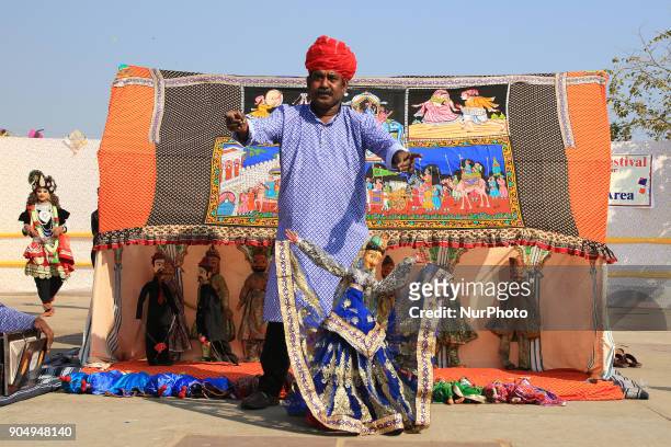 An Indian Puppet artist during the Kite Festival on the occasion of Makar Sakranti at Jal Mahal of Jaipur, Rajasthan,India on 14 January 2018.