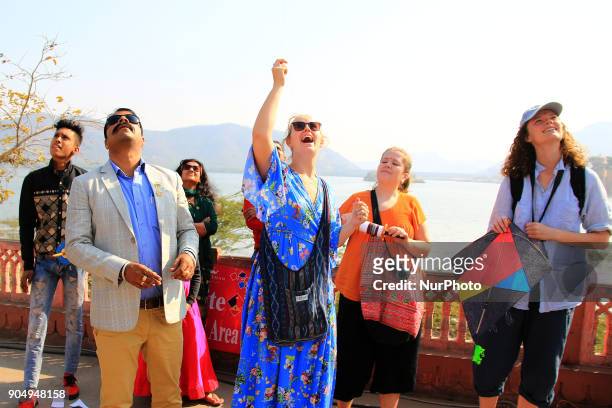 Foreign tourists flying kites and enjoy during the Kite Festival on the occasion of Makar Sakranti at Jal Mahal of Jaipur, Rajasthan,India on 14...