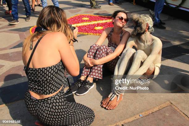 Foreign tourists pose with dress up artist during the Kite Festival on the occasion of Makar Sakranti at Jal Mahal of Jaipur, Rajasthan,India on 14...