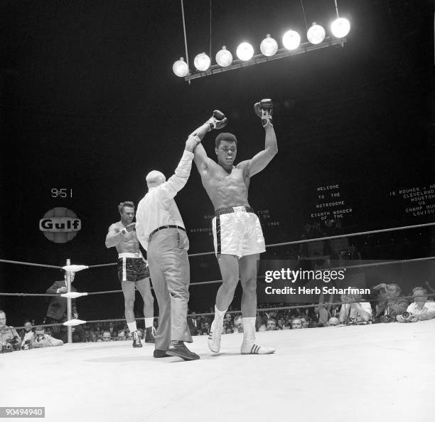 World Heavyweight Title. Muhammad Ali victorious with referee Harry Kessler after winning fight vs Cleveland Williams at Astrodome. Houston, TX...