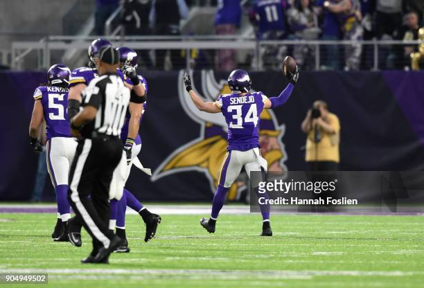 Andrew Sendejo of the Minnesota Vikings celebrates after intercepting Drew Brees of the New Orleans Saints in the first quarter of the NFC Divisional...