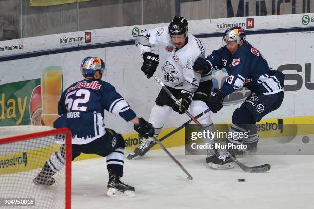 Michael Wolf of Red Bull Munich vies Brett Festerling of Nuernberg Ice Tigers during 42th Gameday of German Ice Hockey League between Red Bull Munich...