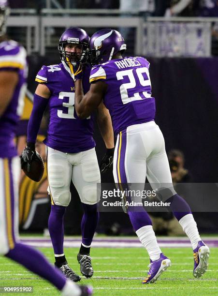Andrew Sendejo of the Minnesota Vikings celebrates with teammate Xavier Rhodes after intercepting Drew Brees of the New Orleans Saints in the first...