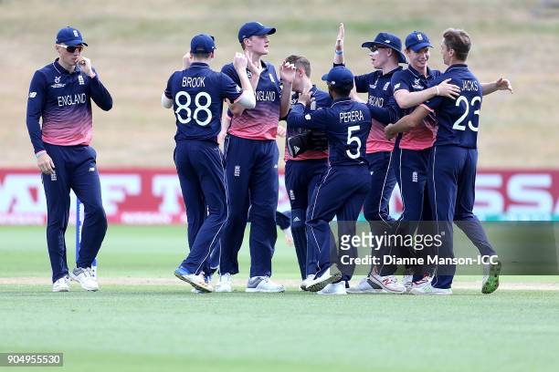 England players celebrate the dismissal of Lohan Louwrens of Namibia during the ICC U19 Cricket World Cup match between England and Namibia at John...