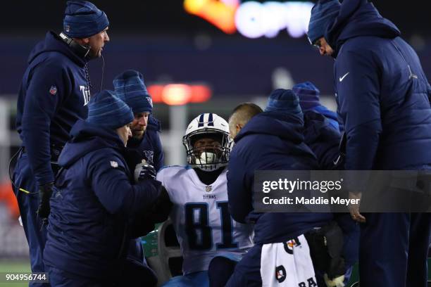 Jonnu Smith of the Tennessee Titans leaves the field due to injury during the AFC Divisional Playoff game against the New England Patriots at...