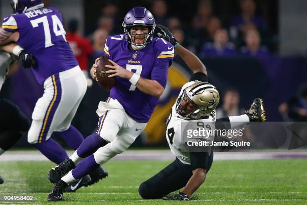 Case Keenum of the Minnesota Vikings scrambles with the ball chased by Cameron Jordan of the New Orleans Saints during the first half of the NFC...
