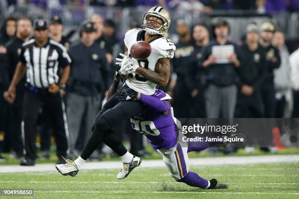 Ted Ginn of the New Orleans Saints makes a catch defended by Mackensie Alexander of the Minnesota Vikings during the first half of the NFC Divisional...