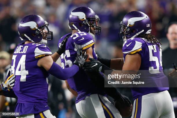 Anthony Barr of the Minnesota Vikings celebrates with Eric Kendricks and Andrew Sendejo after a interception against the New Orleans Saints during...