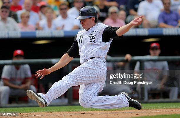 Brad Hawpe of the Colorado Rockies slides home against the Cincinnati Reds at Coors Field on September 7, 2009 in Denver, Colorado. The Rockies...