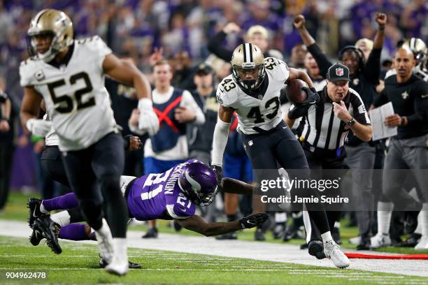 Marcus Williams of the New Orleans Saints runs with the ball after a interception against the Minnesota Vikings during the second half of the NFC...