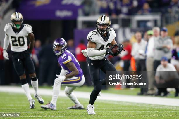 Marcus Williams of the New Orleans Saints runs with the ball after a interception against the Minnesota Vikings during the second half of the NFC...