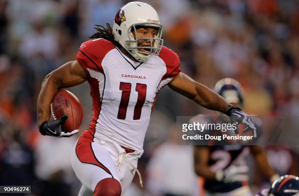 Wide receiver Larry Fitzgerald of the Arizona Cardinals makes a reception and advances the ball against Denver Broncos during NFL preseason action at...