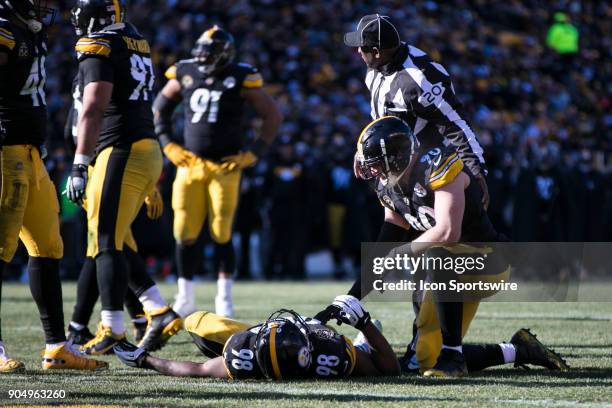 Pittsburgh Steelers outside linebacker T.J. Watt checks on Pittsburgh Steelers inside linebacker Vince Williams after he was injured during the AFC...