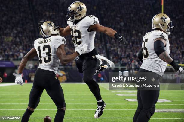 Michael Thomas of the New Orleans Saints celebrates with teammate Mark Ingram after catching the ball for a touchdown in the third quarter of the NFC...