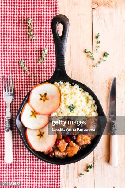 pork stew with dried cranberry served with couscous in a pan, top view - homemade apple sauce stock pictures, royalty-free photos & images