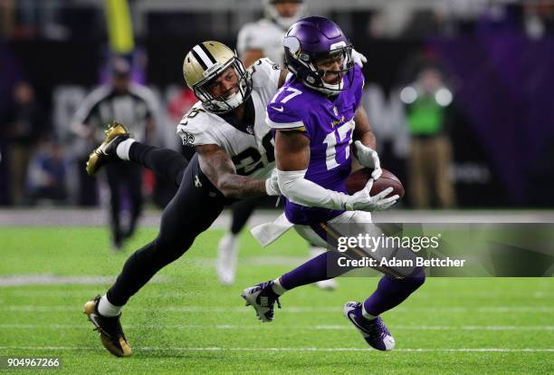 Jarius Wright of the Minnesota Vikings catches the ball over defender P.J. Williams of the New Orleans Saints in the fourth quarter of the NFC...