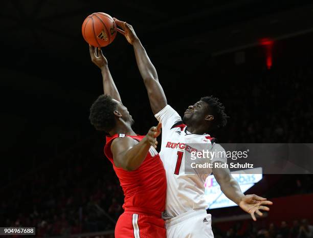 Candido Sa of the Rutgers Scarlet Knights blocks the shot of Jae'Sean Tate of the Ohio State Buckeyes during the first half of a game at Rutgers...