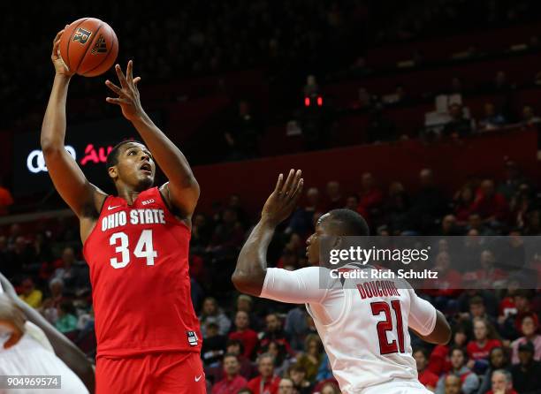 Kaleb Wesson of the Ohio State Buckeyes attempts a shot as Mamadou Doucoure of the Rutgers Scarlet Knights defends during the first half of a game at...