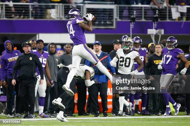 Stefon Diggs of the Minnesota Vikings makes a catch over Marcus Williams of the New Orleans Saints during the second half of the NFC Divisional...