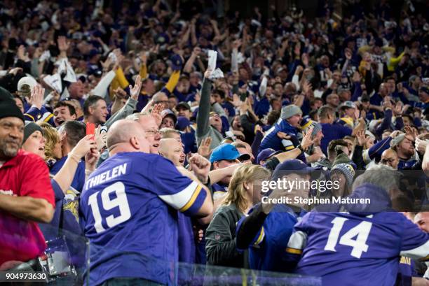 Fans react after Stefon Diggs of the Minnesota Vikings scored a 61 yard touchdown at the end of the fourth quarter of the NFC Divisional Playoff game...