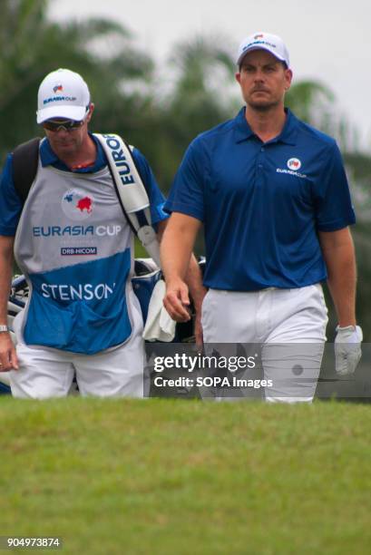 Henrik Stenson is seen walking to another hole with his caddie at the last day of EurAsia Cup. EurAsia Cup is a biennial men professional team golf...