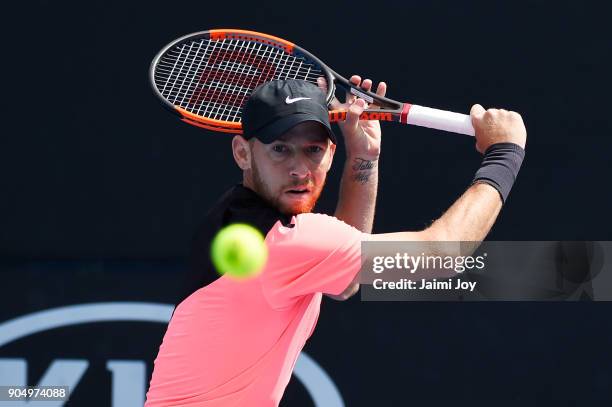 Dudi Sela of Israel plays a backhand in his first round match against Ryan Harrison of the United States on day one of the 2018 Australian Open at...