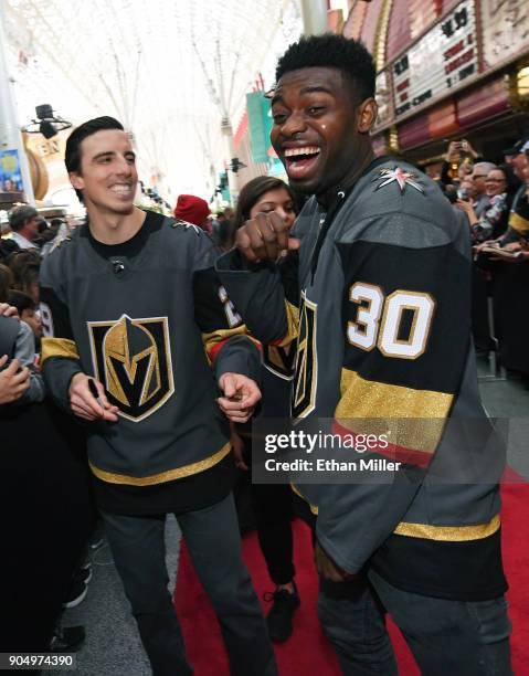 Goaltenders Marc-Andre Fleury and Malcolm Subban of the Vegas Golden Knights laugh as they sign autographs for fans on a red carpet during the Vegas...