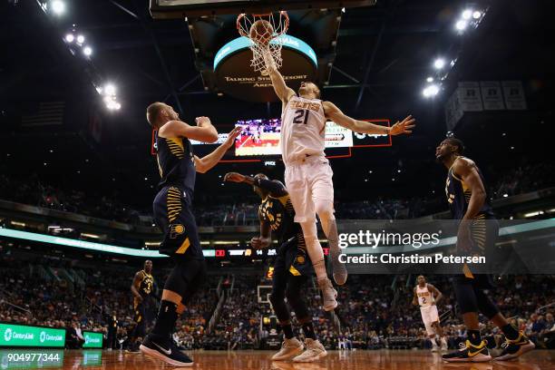 Alex Len of the Phoenix Suns slam dunks the ball over Victor Oladipo of the Indiana Pacers during the first half of the NBA game at Talking Stick...