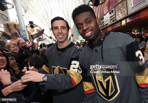 Goaltenders Marc-Andre Fleury and Malcolm Subban of the Vegas Golden Knights pose as they sign autographs for fans on a red carpet during the Vegas...