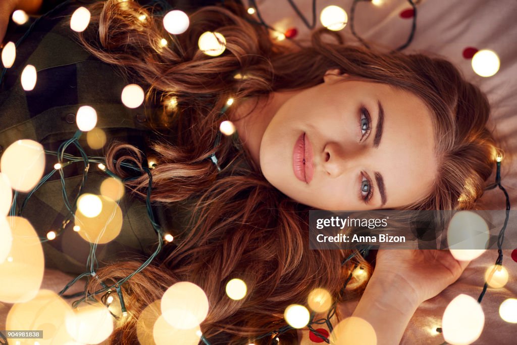 Attractive woman lying on bed and imaging. Debica, Poland