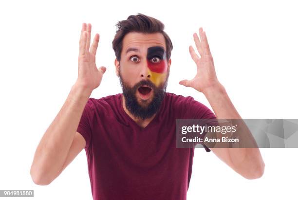 shocked german football fan watching soccer game in disbelief. debica, poland - wow stock-fotos und bilder