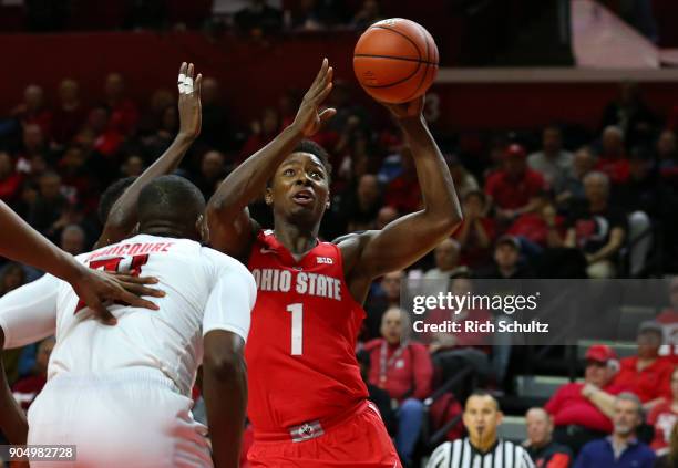 Jae'Sean Tate of the Ohio State Buckeyes attempts a shot as Mamadou Doucoure of the Rutgers Scarlet Knights defends during the first half of a game...