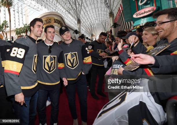 Alex Tuch, Reilly Smith and Reid Duke of the Vegas Golden Knights pose for photos as they walk a red carpet at the Vegas Golden Knights Fan Fest at...