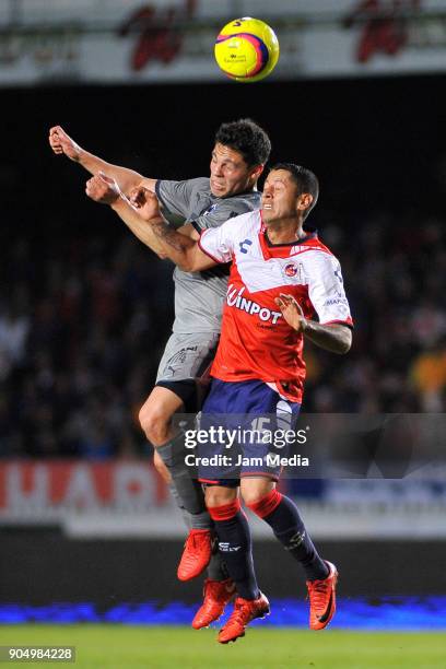 Arturo Gonzalez of Monterrey goes for a header with Carlos Esquivel of Veracruz during the second round match between Veracruz and Monterrey as part...
