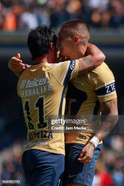 Gustavo Alustiza of Pumas celebrates with teammate Nicolas Castillo after scoring the second goal of his team during the second round match between...