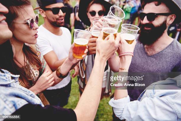 group of friends drinking a beer at the festival. krakow, poland - drinking beer festival stockfoto's en -beelden