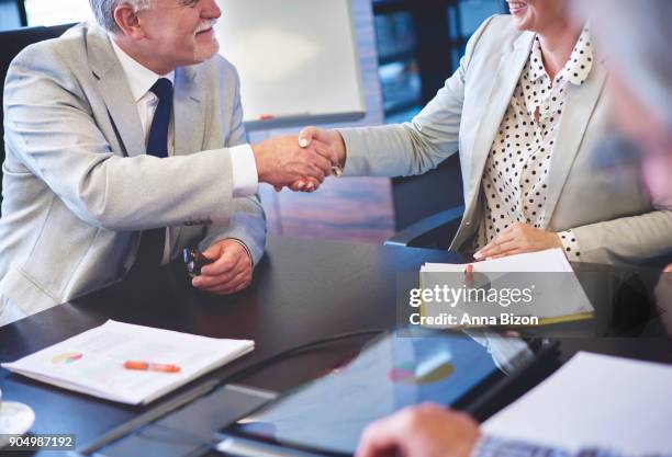 close up of business couple shaking hands. rzeszow, poland - lower employee engagement stock pictures, royalty-free photos & images