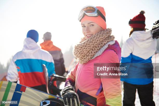 woman in ski clothes with friends on the background. zakopane, poland - anna bergman stockfoto's en -beelden